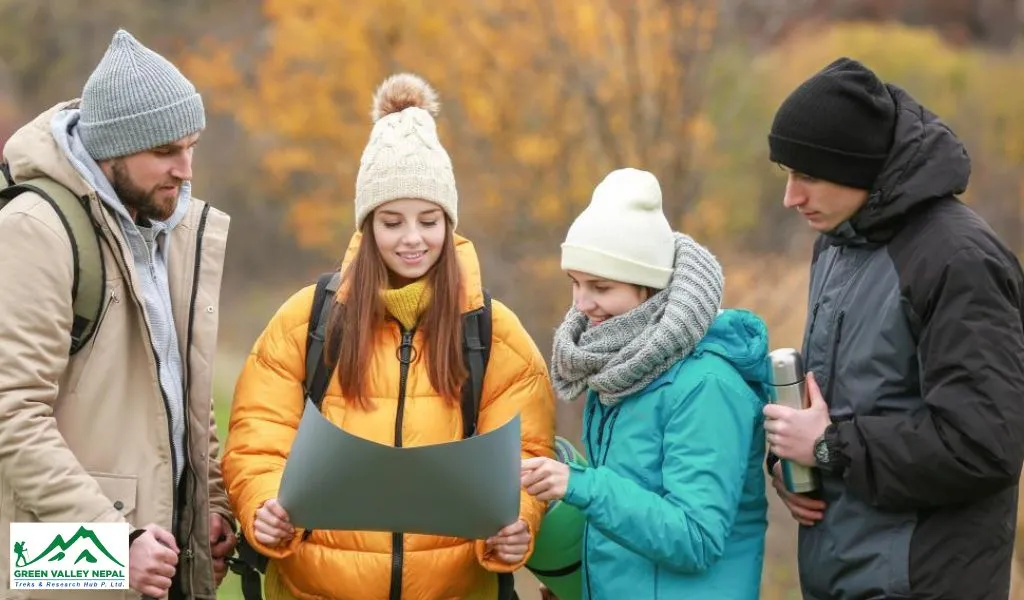 people-wearing-trekking-jacket-looking-at-a-map