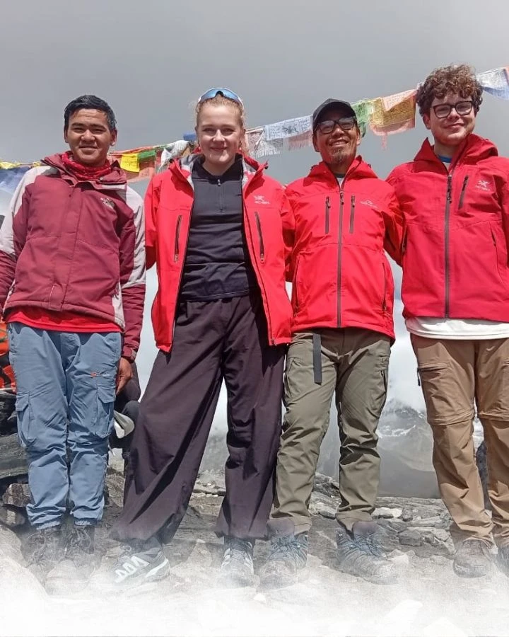 Team Photo Under the Prayer Flags
